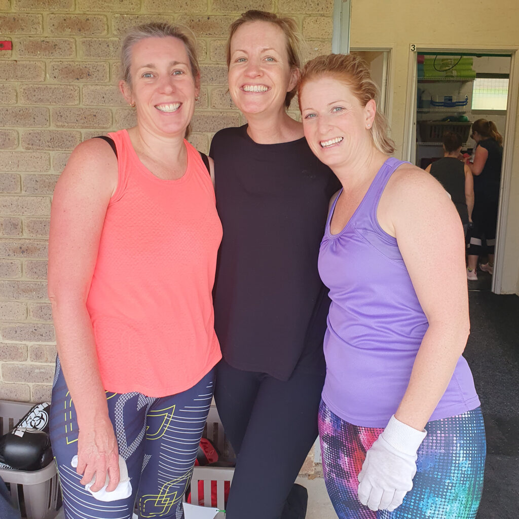 Three women in workout clothes